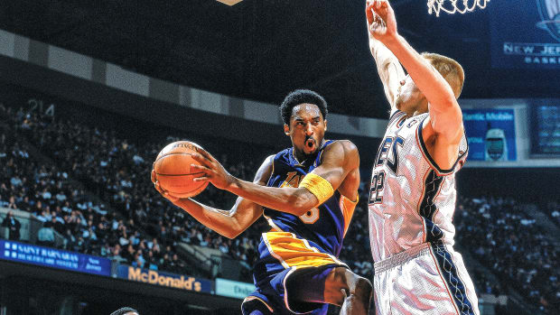 Kobe Bryant holding a basketball in mid-air